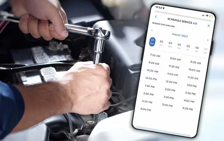 A mechanic uses a wrench on a car engine while a phone screen shows a 'Schedule Service' app.