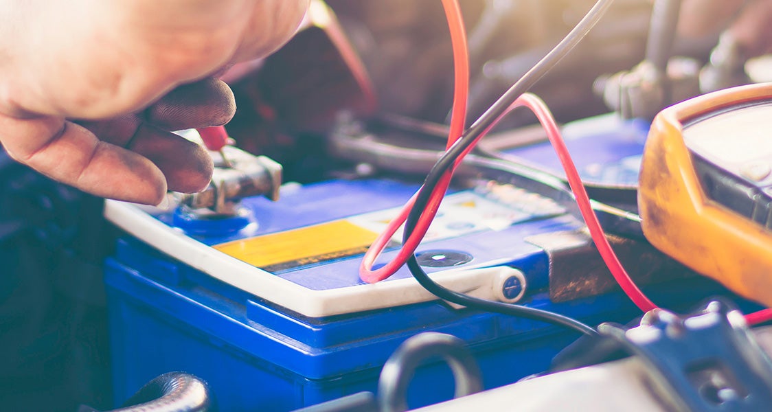 mechanic servicing car battery